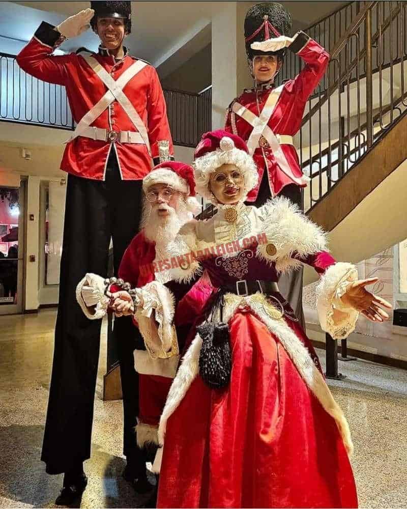 Hire Santa Durham party look with Santa, Mrs. Claus and nutcracker soldiers on stilts