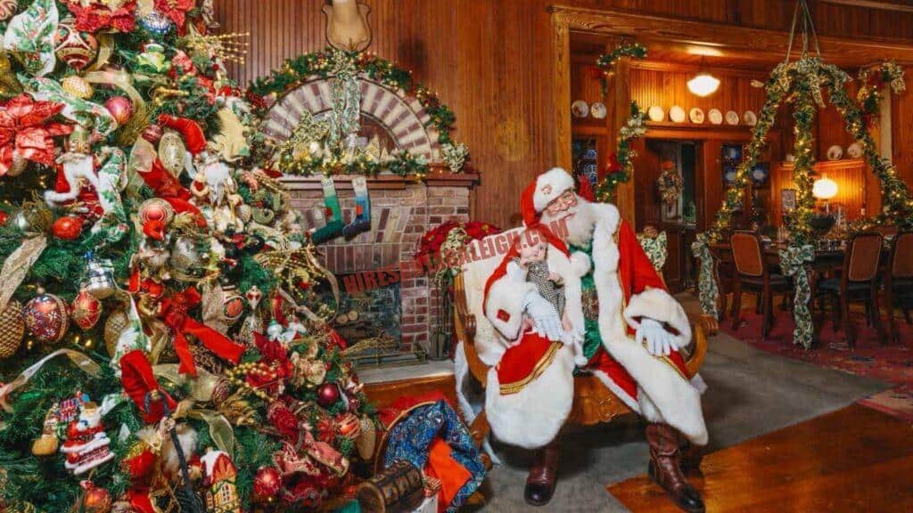 Santa service areas in the Triangle: a living-room booking with Santa beside a tree and brick fireplace