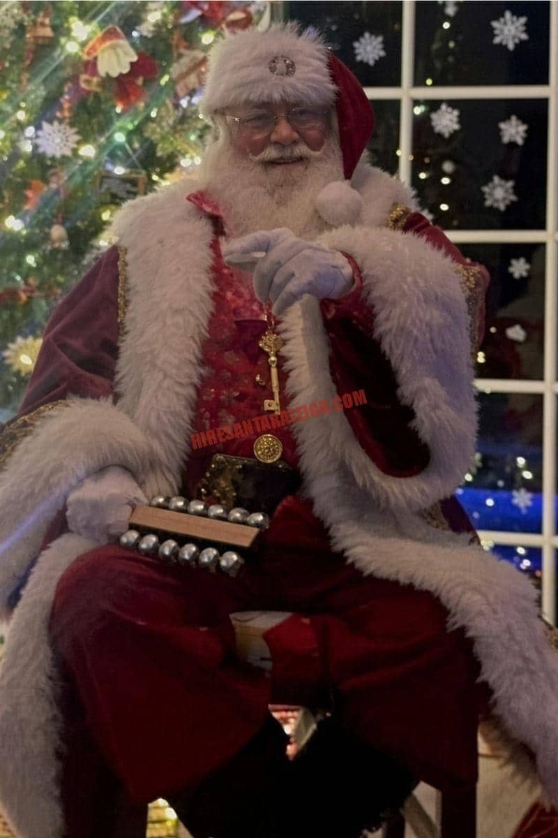 Hire Santa Cary living-room stop with Santa by a lit tree and frosted window